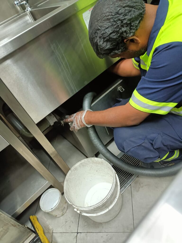 Man Doing Grease Trap cleaning Image