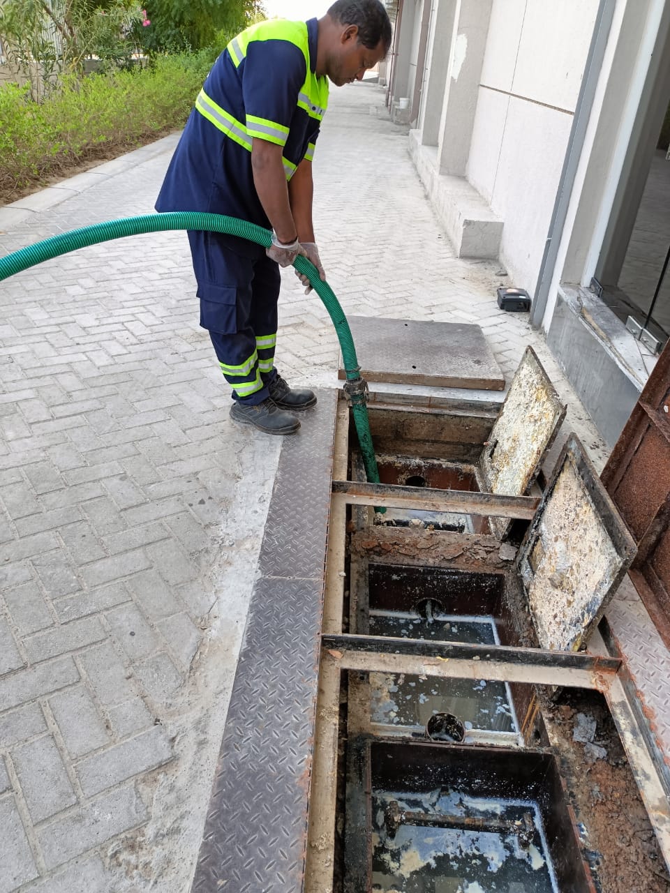 Man Doing Grease Trap cleaning Image