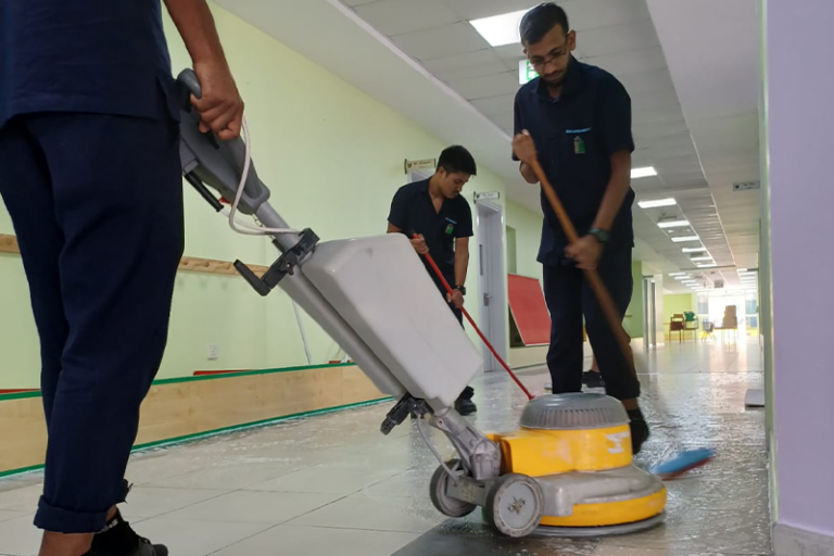 A group of people are providing deep cleaning service along with the dosing machine Image